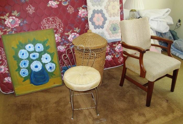 Vintage Occasional Arm Chair with nicely carved curved arms, rich finish, beige upholstered seat and back; Brass Vanity Chair with scrolled brass frame and gold colored cushion.  Also shown are a  King Size Bed Set...King Mattress & Boxsprings with floral cover, large wicker weave clothes hamper, and artwork that are also available.