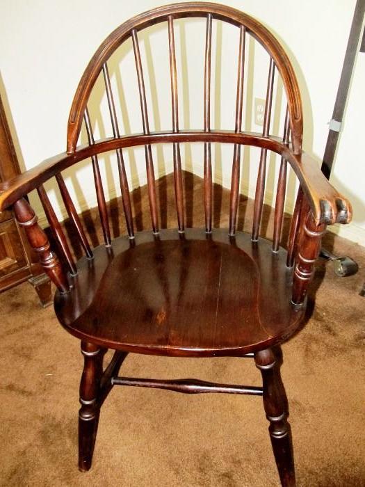 Vintage Nicely Curved Spindle Back Captains Chair with paw carved arms and dark finish
