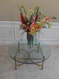 Living Room:  42" round glass top on brass stand; floral arrangement in glass cylinder vase is 40" tall.