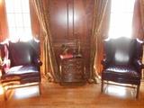 Library:  Pair of KNOB CREEK top grain leather burgundy wingback chairs with nail-head trim (priced separately); Small four-drawer KNOB CREEK chest measures 24" x 15" x 24" tall; brass décor includes an eagle  figure and brass candlestick with glass.