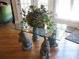 Kitchen/Hearth Room:  A herd of very serious bunnies support a (42" x 29") glass top which, in turn,  supports a floral arrangement.