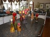 Kitchen:  A large 27" tall glass/metal urn filled with decorative fruit; jars of decorative items.