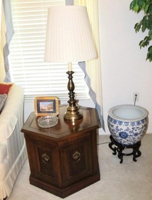 Vintage Traditional Style Octagonal Shaped End Table with walnut finish and cabinet door storage with brass pulls.  End Table is matching to Vintage Traditional Style Coffee Table, Vintage Traditional Style Sofa / Foyer Table, and other Vintage Traditional Style End Tables  which are shown elsewhere in this collection; Oriental Style  Goldfish Bowl with stand are also available as are  and cut glass dish and the stylish brass accent table lamp shown