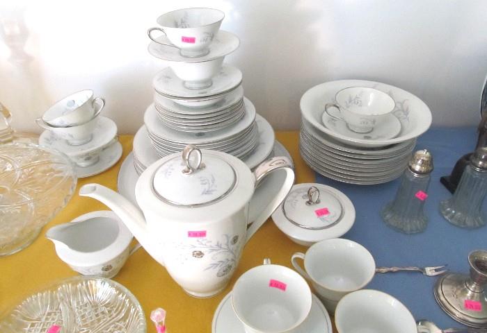 One of Several China Sets available in this sale...This is a partial set of bone china with silver trim and floral accents.  Pressed Glasss items and silver plate candle holders and salt & pepper sets are also available