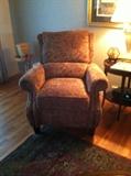 Never used reclining chair featuring burgundy and olive paisley fabric; featuring nail head trim. 2 matching pillows trimmed in leather available.