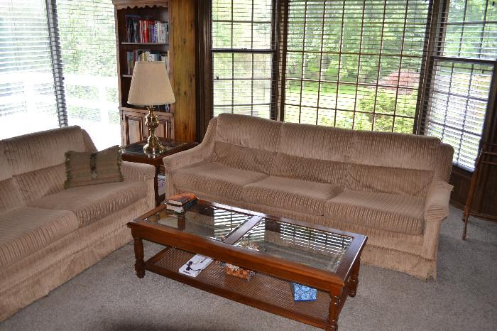 Matching gold sofas provide comfortable seating for den or family room. Glass top coffee table in great condition.