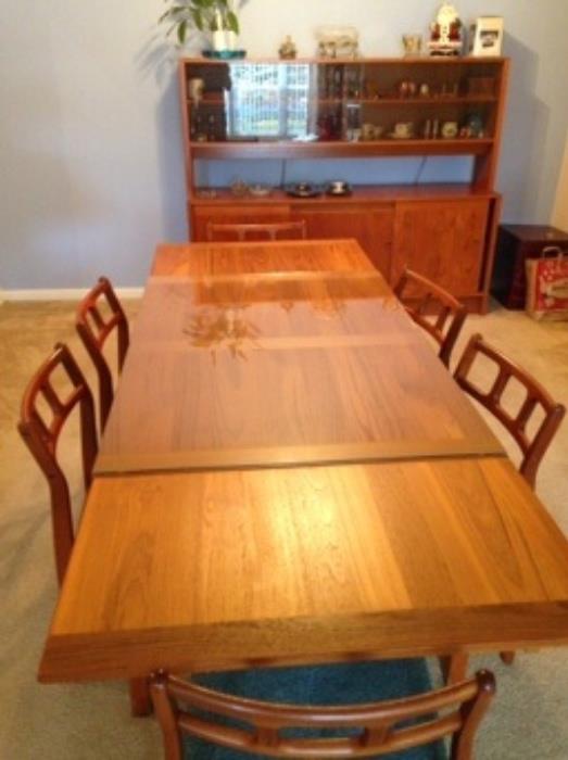 Beautiful 30 year old House of Denmark teak table with pull out leafs and six chairs.