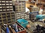 Even more tools, screws, bolts, and many other items across the tool benches along the garage walls