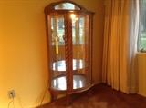Oak curio cabinet with mirrored back, glass shelves, and an interior light. It also has a locking curved glass door!