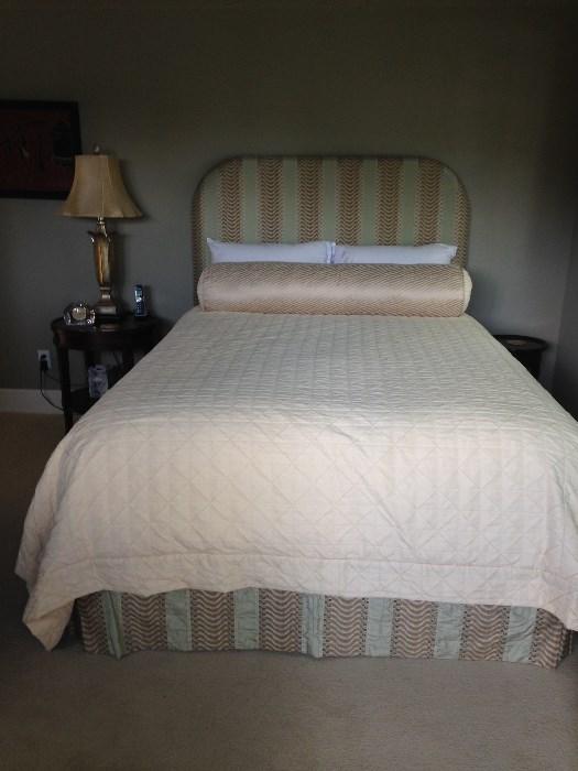 Upholstered queen headboard and frame along with a New Englander mattress set for sale. Lamp is in the sale but the table is not