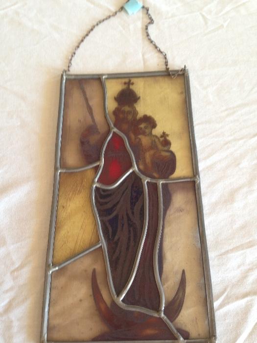 Old religious stained glass window hanging
