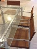 glass and chrome table with 6 leather and chrome chairs 