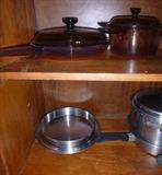 Brown Pyrex pots and lids. Heavy-duty pie pans (2) and biscuit pans (2).