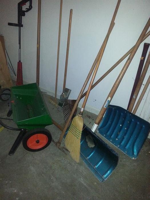 A variety of yard tools in garage.