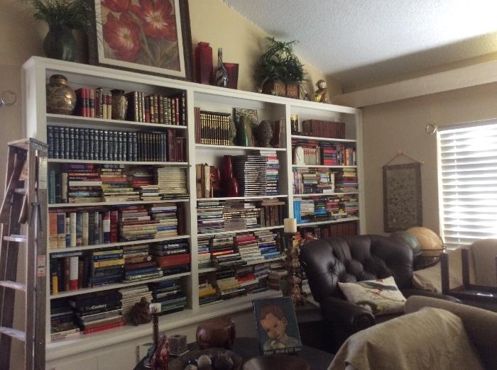 Loafs of books and beautiful decorative items. World globes, slate topped tables and leather chair. 