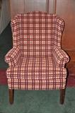 Upholstered plaid wing back chair