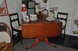 Christmas decor sitting atop a vintage drop leaf table