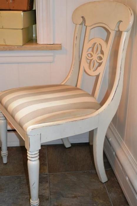 1 of 8 painted white chairs