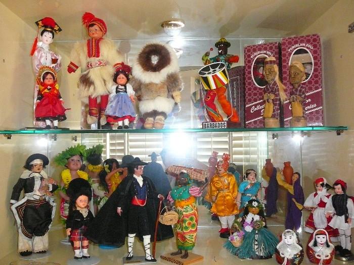 Large collection of International dolls, some vintage dolls, some with boxes,  Vintage international souvenirs.