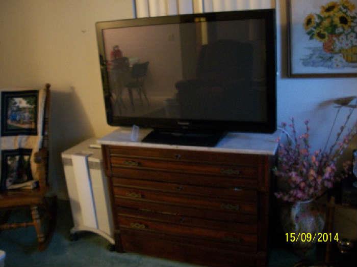 Antique 3 drawer dresser with marble top and 42" flat screen