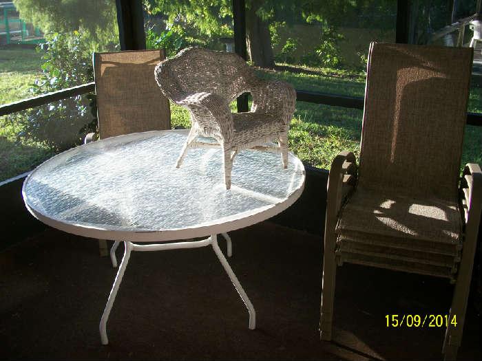 glass top patio table, 4 chairs and child's wicker chair
