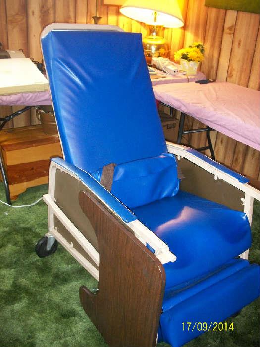 Hospital chair/recliner with adjustable tray table.