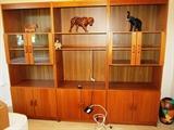 3  Scan Design Teak Bookcases ...two with glass & wood doored and shelves storage, other open shelves storage and lower double doored cabinet storage; One has large open shelf storage suitable for a TV , other open shelves storage and a lower double door cabinet storage.  Carved Animals shown are not available.