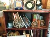 books, records, film canisters, bookends and a primitive book case