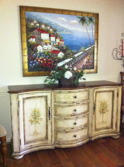 Large hand-decorated buffet with large original painting and floral arrangement.