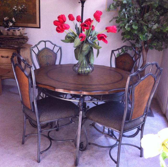 Casual dining table and 4 chairs--heavy wrought iron, upholstered seats, faux leather textured table-top.