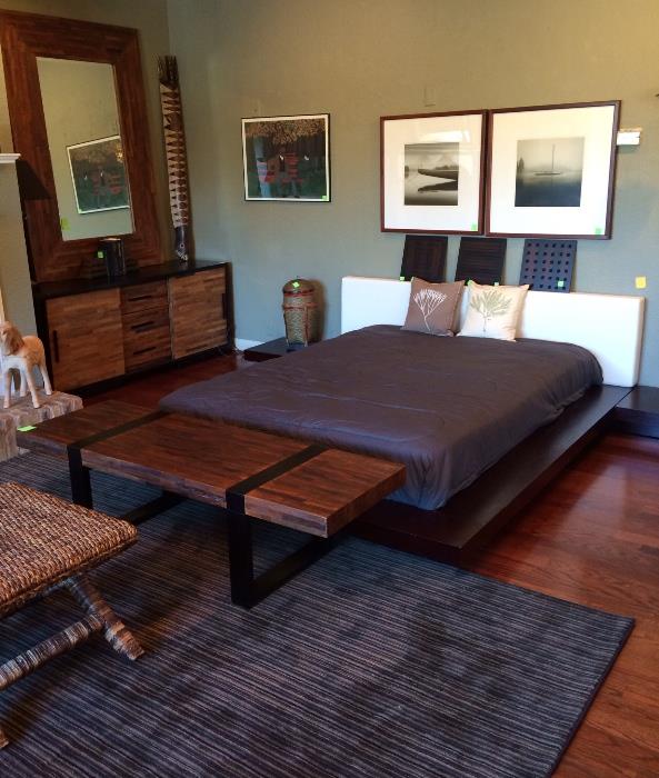 Queen platform bed, photographs, striped rug, wood and metal bench, barn wood buffet and mirror.