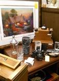 framed art, pipes, pipe stand, camera, desk, table, etc.