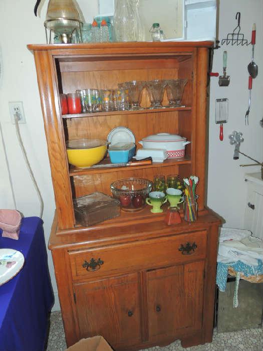 kitchen cupboard has glass door, vintage kitchen collectibles