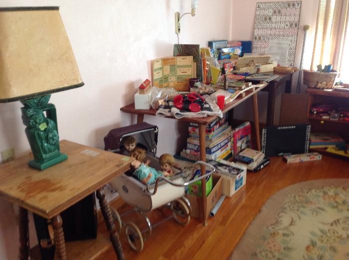 Vintage hooked rug, antique table, vintage toy baby carriage, dolls, Tonka toys,Lego's, sewing machine, numerous games