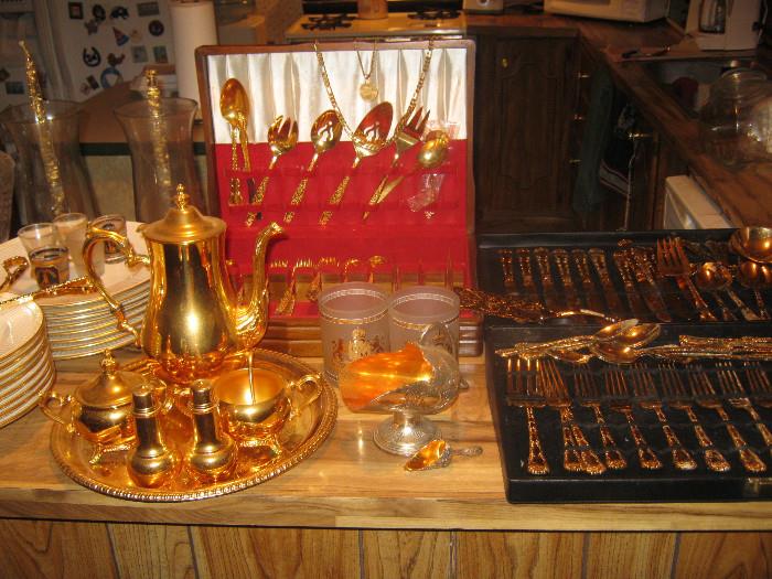 131 peaces of Mikasa empire gold   from Japan,golden dinner ware, talk about fine china plus 2 golden candles stick with crystal and gold holders,12 large forks,12 large spoons,12large  knifes,gold cake knife,etc,etc,etc  