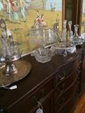 Antique buffet; silver-plate serving pieces; cake plates; decanters;