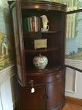 Two-door Duncan Phyfe corner cabinet (curved front);