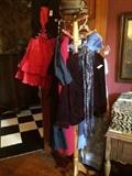 Vintage clothing & hats on another hat rack;