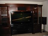 Home theater wall unit, 60" LCD TV, surround sound system, custom premium speakers.