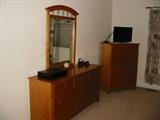 Dresser, mirror, and chest-of-drawers from master bedroom set. LCD TV