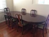 Queen Anne style dark wood table with three leaves and six chairs