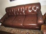 Worn leather Chesterfield style sofa