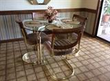 Glass top dinette table and four chairs.