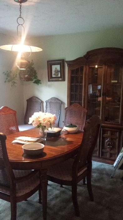 Dining room table, chairs, and  china cabinet. Also has two leaf inserts