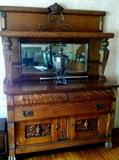 Highly figured and carved quarter sawn oak sideboard cupboard with beveled glass mirror, excellent condition for period