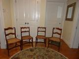 Four of eight caned side chairs