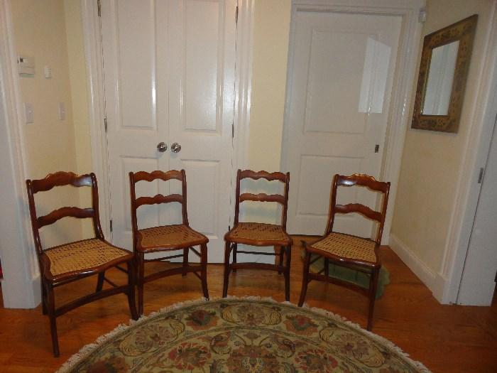Four of eight caned side chairs