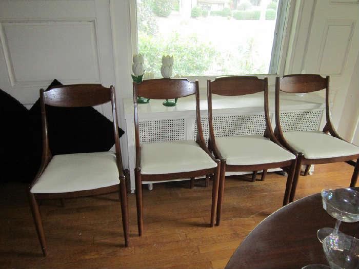 There are 8 mid-century modern chairs