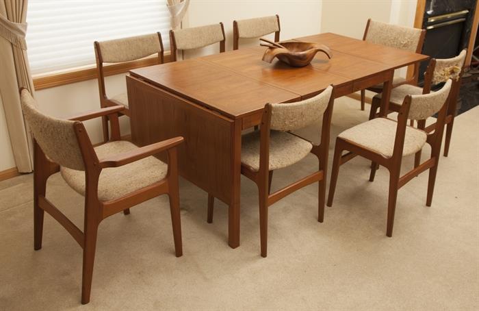 Danish dining table (108" L x 35.5 W x 28.5 T) with two removable leafs, 8 chairs, chair upholstery has condition issues