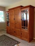 Mission-style entertainment center, side cabinets with interior lighting, two shelfs and glass doors